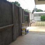 the steel-gated and concrete fence